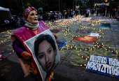 Family members and friends of missing persons participate in a candlelight vigil, in Mexico City