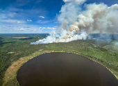 Smoke rises from wildfire SWF085 of the Red Earth East Complex, northwest of Fort McMurray