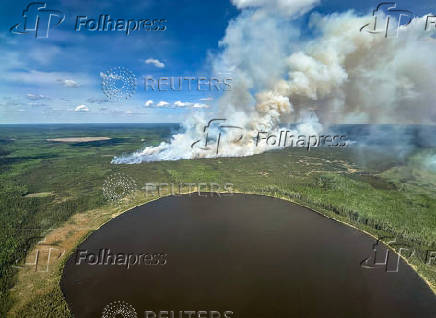 Smoke rises from wildfire SWF085 of the Red Earth East Complex, northwest of Fort McMurray
