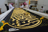 Workers prepare the Kiswa, a silk cloth that covers the Kaaba, ahead of the annual hajj pilgrimage