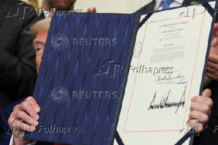 U.S. President Trump signs a resolution at the White House
