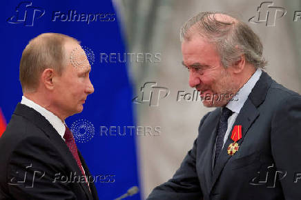 FILE PHOTO: Russian President Putin awards Mariinsky Theatre's Artistic Director Gergiev during a ceremony at the Kremlin in Moscow