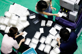 Election officials count votes at a ballot counting centre for Japan's upper house election in Tokyo