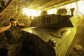 Ukrainian servicemen fire a self-propelled howitzer towards Russian troops at a frontline near the town of Chasiv Yar