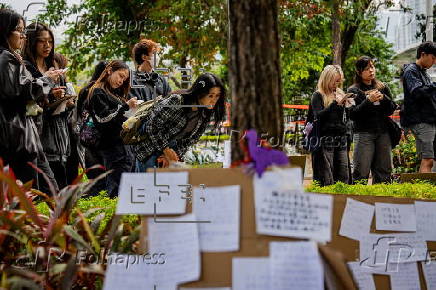 Roadside memorial for victims of the high-rise apartment fire in Hong Kong