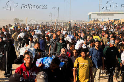 Palestinians receive aid from the U.S.-backed Gaza Humanitarian Foundation, in Khan Younis