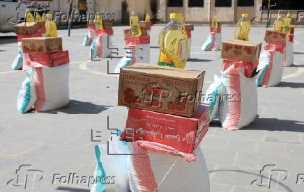 Yemenis receive food aid in Sana'a, distributed by Mona Relief agency