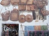 People shop next to a wall mural at Kampong Glam district in Singapore