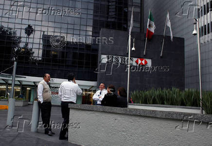 FILE PHOTO: People stand outside British bank HSBC's headquarters in Mexico City