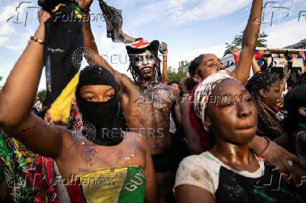 Revelers attend J'ouvert celebration on the day of the annual West Indian Day parade in the Brooklyn borough of New York