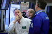 Traders work on the floor of the NYSE in New York