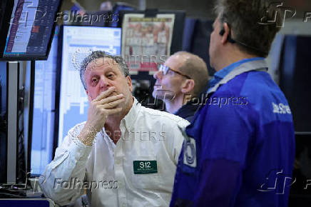 Traders work on the floor of the NYSE in New York
