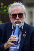 Former Sinn Fein President Gerry Adams sits outside the High Court, in Dublin