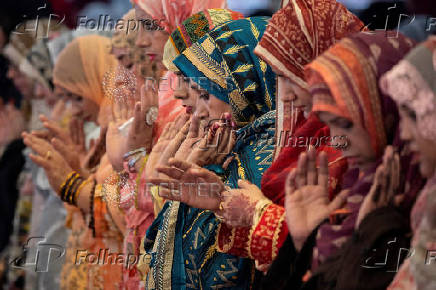 Women take part in Eid ul-Adha prayer at the Badshahi Mosque in Lahore