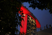 The Marina Bay Sands hotel is illuminated in the evening in Singapore