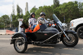 Edmonton Oilers fans ride a motorcycle ahead of the first game of the Stanley Cup Finals against the Florida Panthers in Edmonton