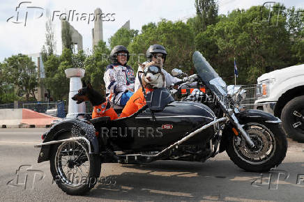 Edmonton Oilers fans ride a motorcycle ahead of the first game of the Stanley Cup Finals against the Florida Panthers in Edmonton
