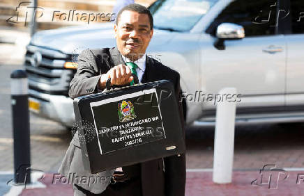 Tanzania?s Minister for Finance Mwigulu Nchemba, holds up a briefcase containing the Government Budget for the 2025/2026 fiscal year in the National Assembly in Dodoma