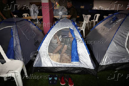 A migrant family from the Philippines prepares to spend the night in an old nuclear shelter under Tel Aviv's central bus station