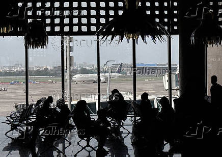 FILE PHOTO: People wait to board their flight at the Chhatrapati Shivaji Maharaj International Airport in Mumbai