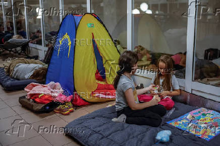 People take shelter inside a metro station during an air raid alert in Kyiv