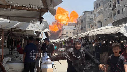 Smoke and flames rise from a house hit by an Israeli strike in Gaza City