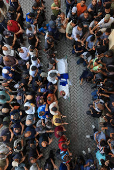 Mourners carry the body of a Palestinian journalist, Suleiman Hajjaj, who was killed in an Israeli airstrike, in Gaza City