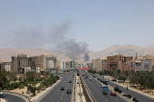 Smoke rises following what Iran says was an Israeli attack on Sharan Oil depot in Tehran