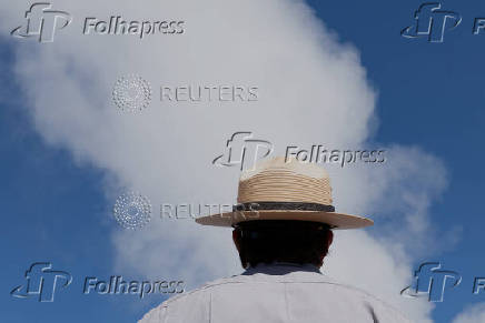 National Park Service Seasonal Interpretation Ranger Denine Northup watches as three geysers erupt simultaneously during her program at the Fountain Paint Pot geothermal area in Yellowstone National Park