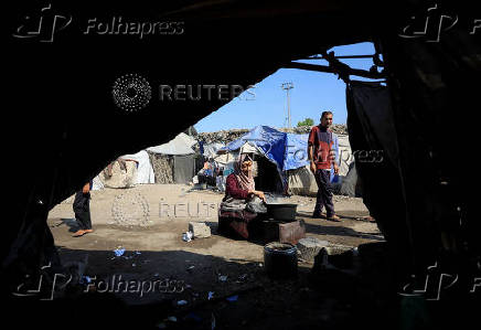 Displaced Palestinians who have not received humanitarian aid survive on leftover food, in Gaza