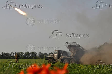 Ukrainian servicemen fire a multiple rocket launcher towards Russian troops on a front line in Zaporizhzhia region