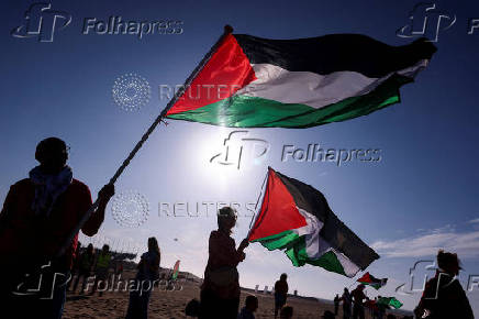 Pro-Palestinian protesters demonstrate on the Zuiderstrand beach against the violence in Gaza