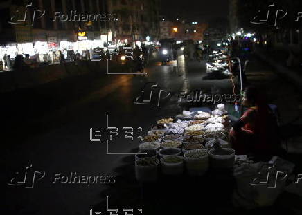 Street vendor sells dry fruits on a roadside in Karachi