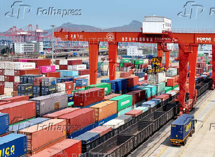 FILE PHOTO: Cargos are uploaded onto a China-Europe freight train at the China-Kazakhstan (Lianyungang) Logistics Cooperation Base