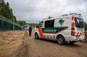 Finnish Border Guard at the barrier fence between Finland and Russia