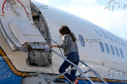 U.S. Homeland Security Secretary Kristi Noem boards her plane at Joint Base Andrews