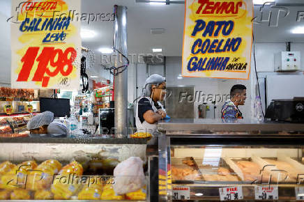A chicken vendor works in a market in Sao Paulo
