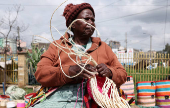 Veronica Musango weaves sisal and recycled polythene to make a traditional handwoven basket known as Kiondo at the Mwariro Market in Kariokor district of Nairobi