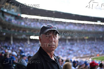 A man looks on as baseball fans watch the Chicago Cubs and the Milwaukee Brewers at Wrigley Field in Chicago