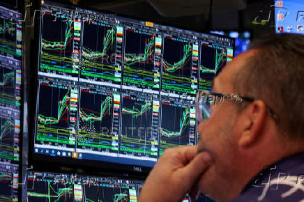 FILE PHOTO: Traders work on the floor of the NYSE in New York