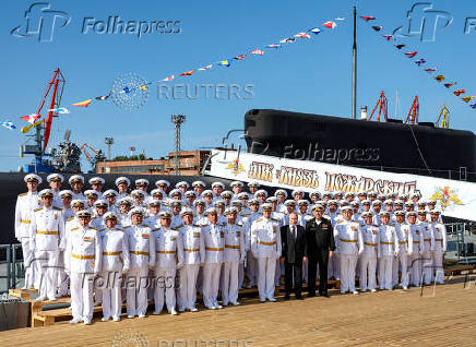 Russian President Vladimir Putin attends a ceremony of raising a naval flag aboard the Knyaz Pozharsky nuclear-powered ballistic missile submarine in Severodvinsk