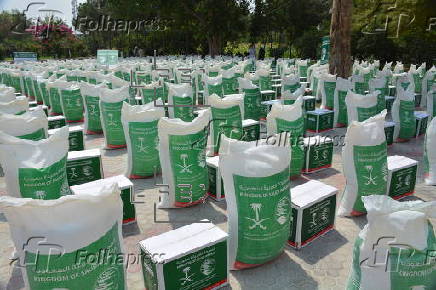 Afghan families, returned from neighboring Pakistan, receive food rations distributed by the Tawheed Charity Foundation in Jalalabad