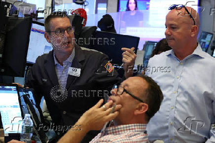 Traders work on the floor of the NYSE in New York
