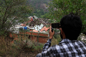 A media person films Bilal Mosque after it was hit by an Indian strike in Muzaffarabad