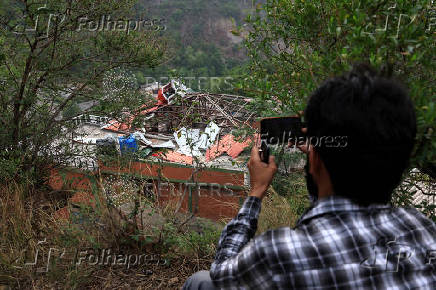 A media person films Bilal Mosque after it was hit by an Indian strike in Muzaffarabad