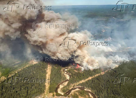 Smoke rises from wildfire SWF076, which has prompted a one-hour evacuation notice for the nearby town of Swan Hills