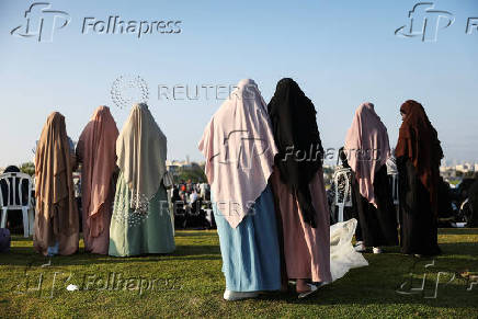 Israeli Muslims pray on the first day of the Muslim holiday of Eid al-Adha by the sea side of the Mediterranean, in Jaffa
