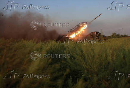 Ukrainian servicemen fire a Grad MLRS towards Russian troops in Donetsk region