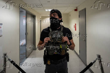 A migrant is detained by federal immigration officers at U.S. immigration court