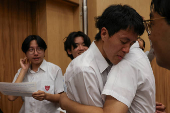 Secondary school students react after receiving their Diploma of Secondary Education (DSE) exam results in Hong Kong